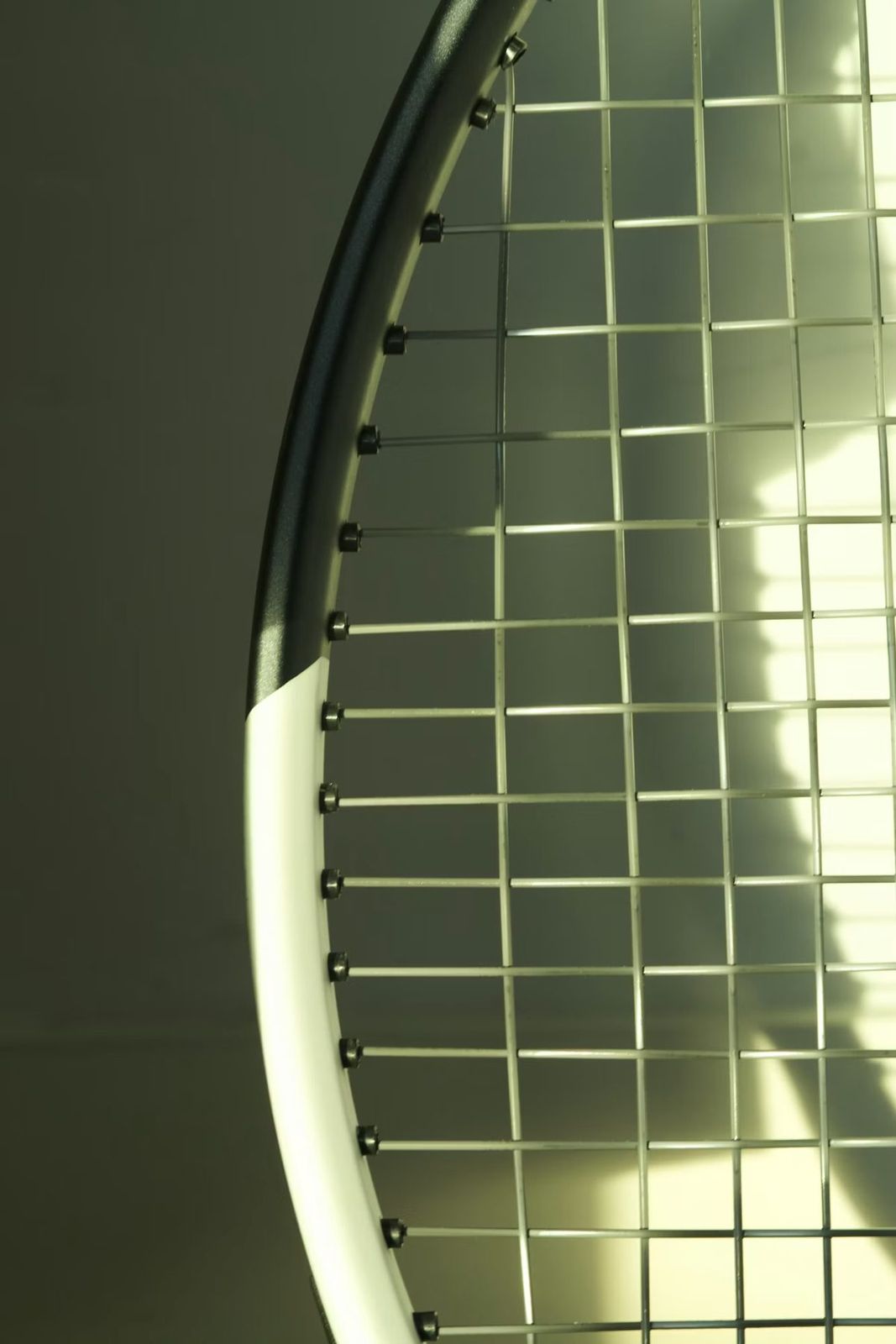 Close-up of a racket frame, grommets and string bed